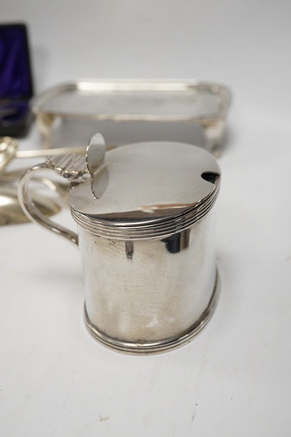 A George III silver teapot stand by Urquhart & Hart, London, 1804, an Edwardian silver mustard pot and assorted silver flatware. Condition - poor to fair to good